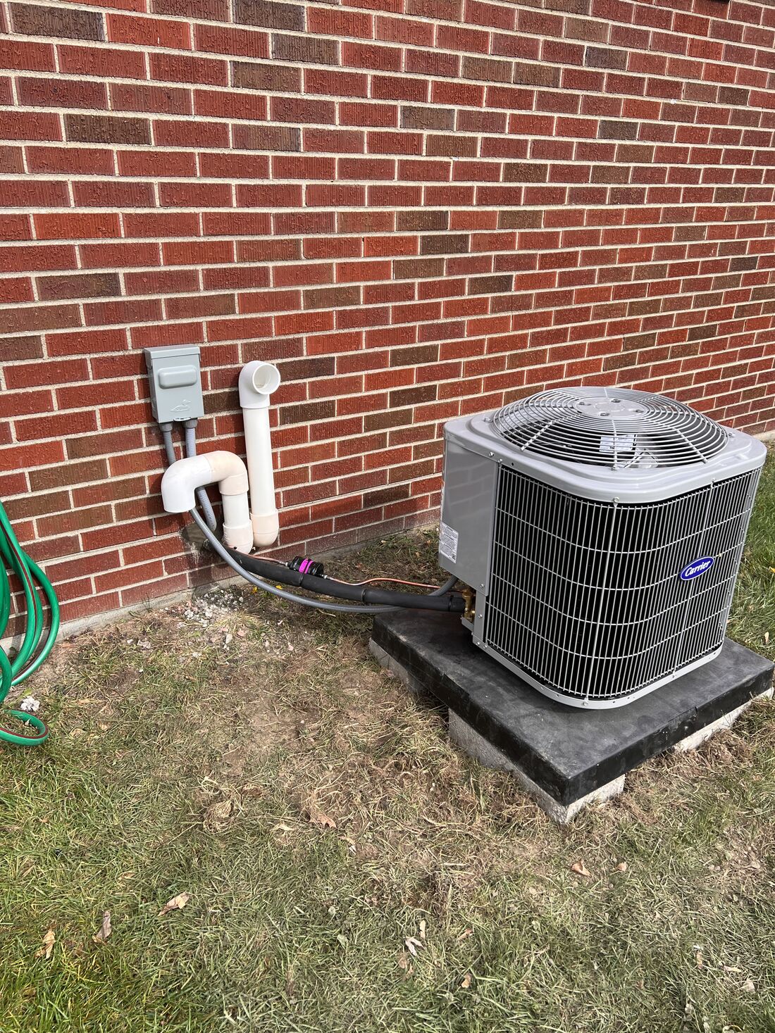 Condenser unit on a brick patio